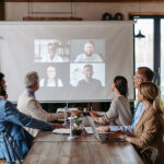 Employees Having Online Business Conference Video Call On Screen