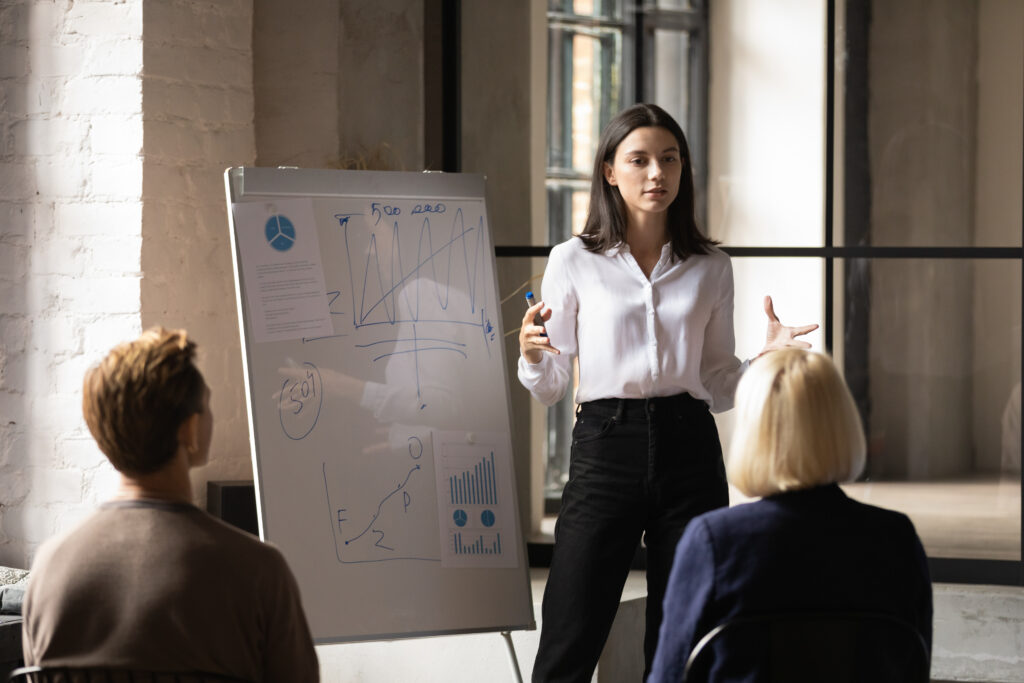 Young Professional Woman in Business Environment Confidently Speaking